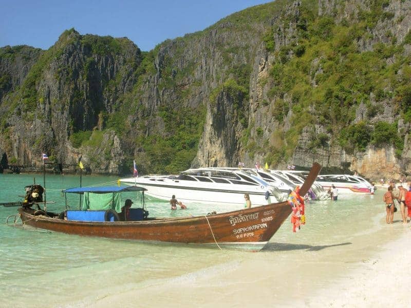 Longtail and speedboats moored on the beach at Maya Bay.
