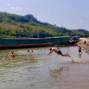 Taking a swim in the Mekong during one of the village stops, Mekong slow boat adventure